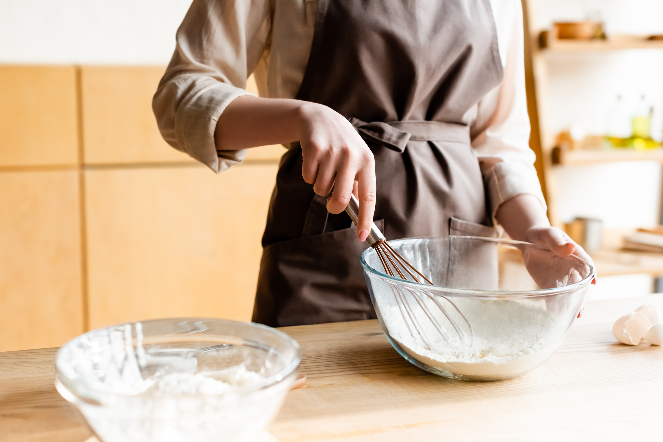 cropped view girl holding whisk