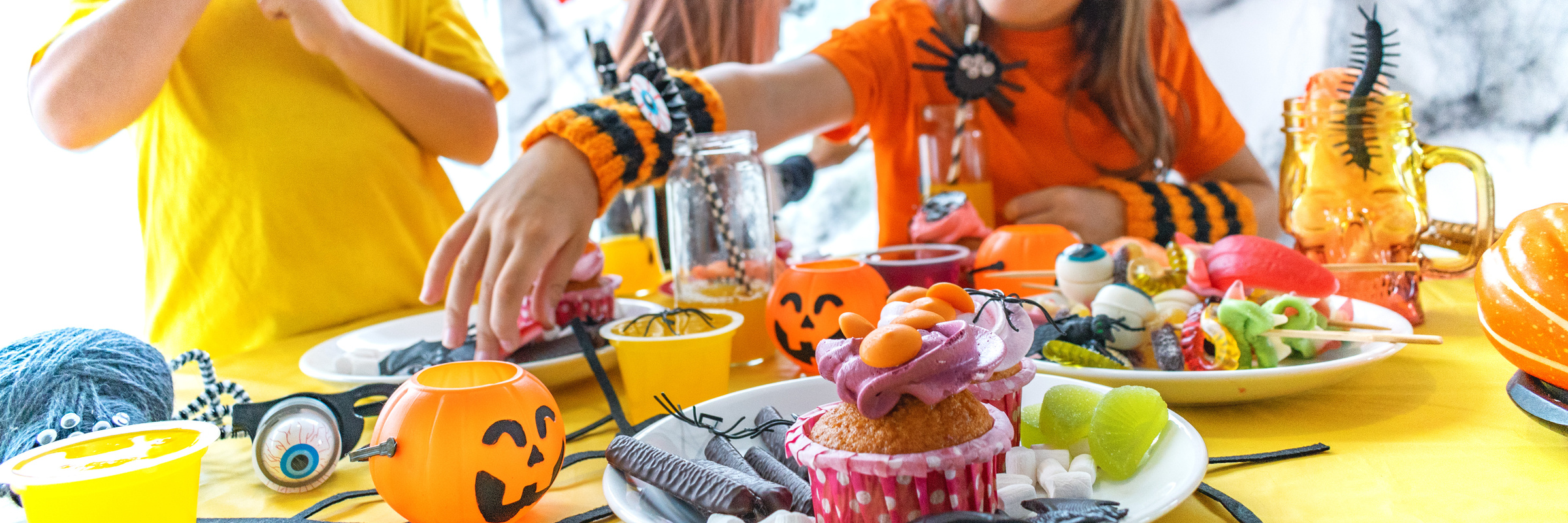 Cute little children with table with sweets.